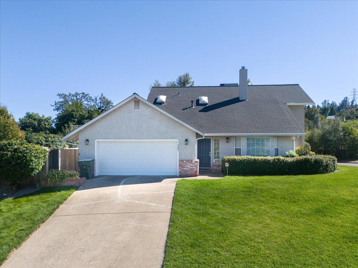 a front view of house with yard and green space