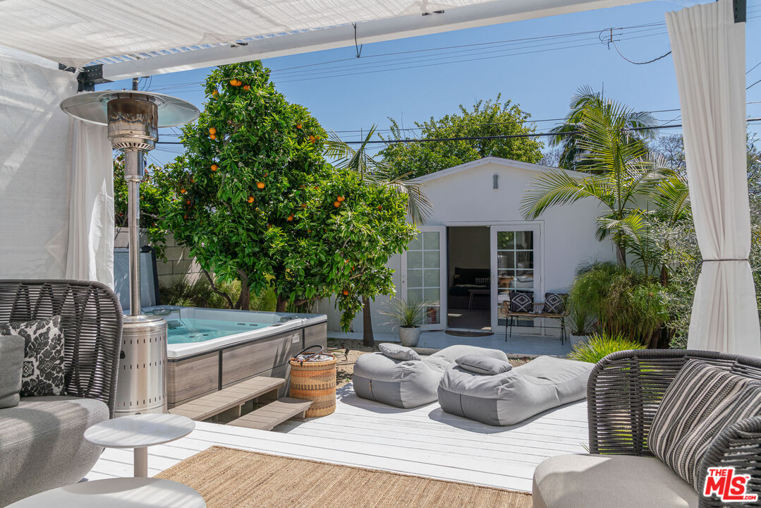 a view of a patio that has couches chairs and a potted plant