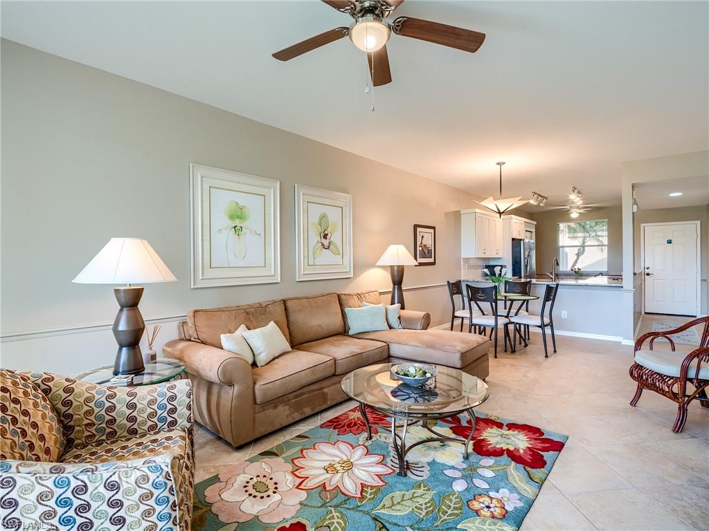 a living room with furniture and a dining table