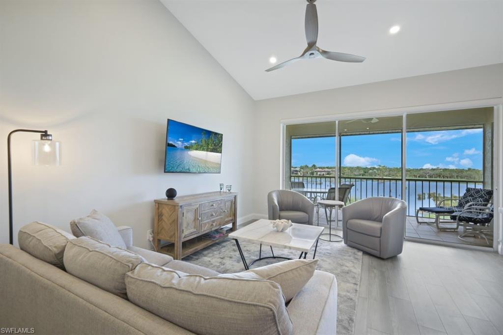 a living room with furniture a ceiling fan and a window