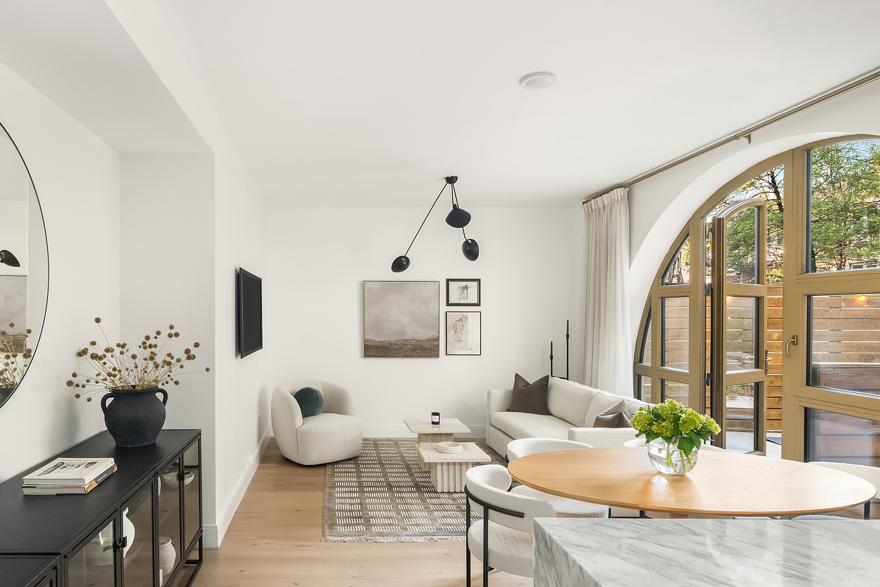 a living room with furniture and wooden floor