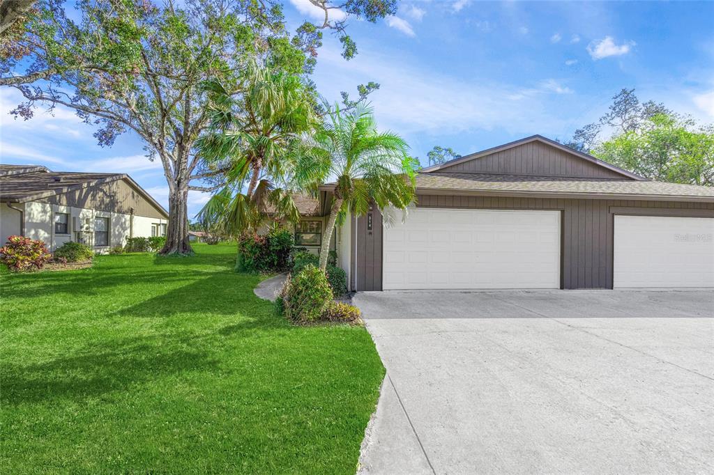 a front view of a house with a yard and garage