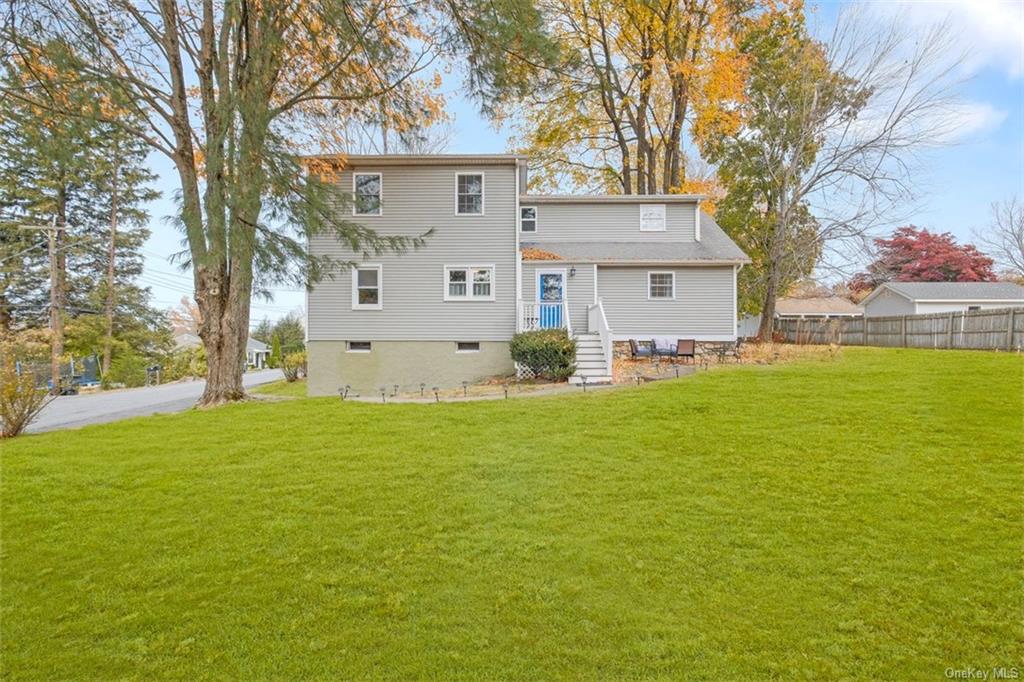 a front view of house with yard and trees