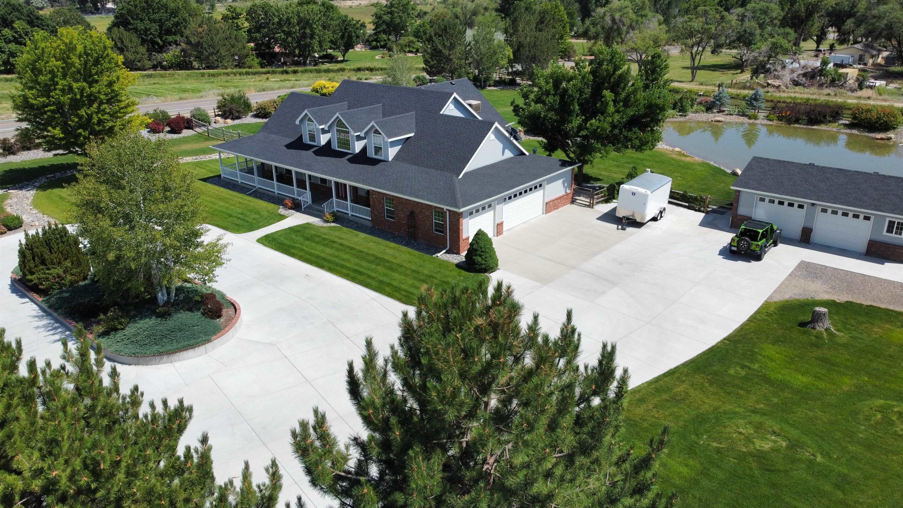 an aerial view of a house with garden space and lake view