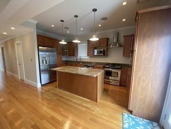 a large kitchen with stainless steel appliances granite countertop a stove and a sink