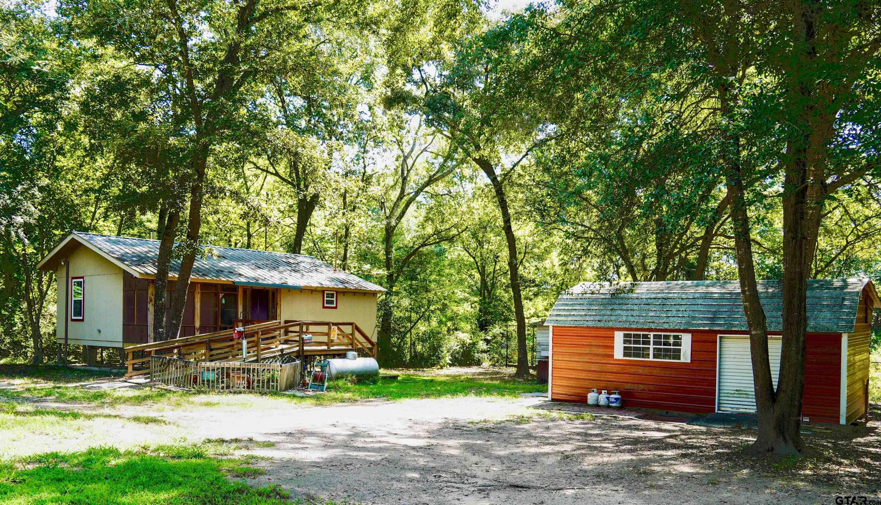 a front view of a house with a yard and tree