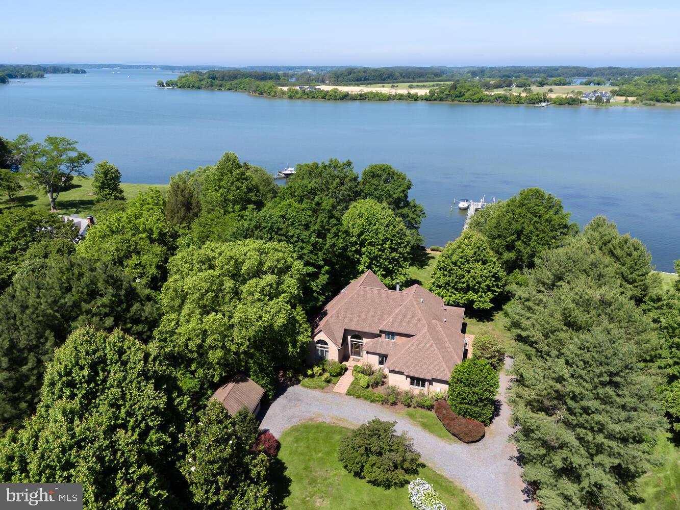 an aerial view of a houses with outdoor space and lake view