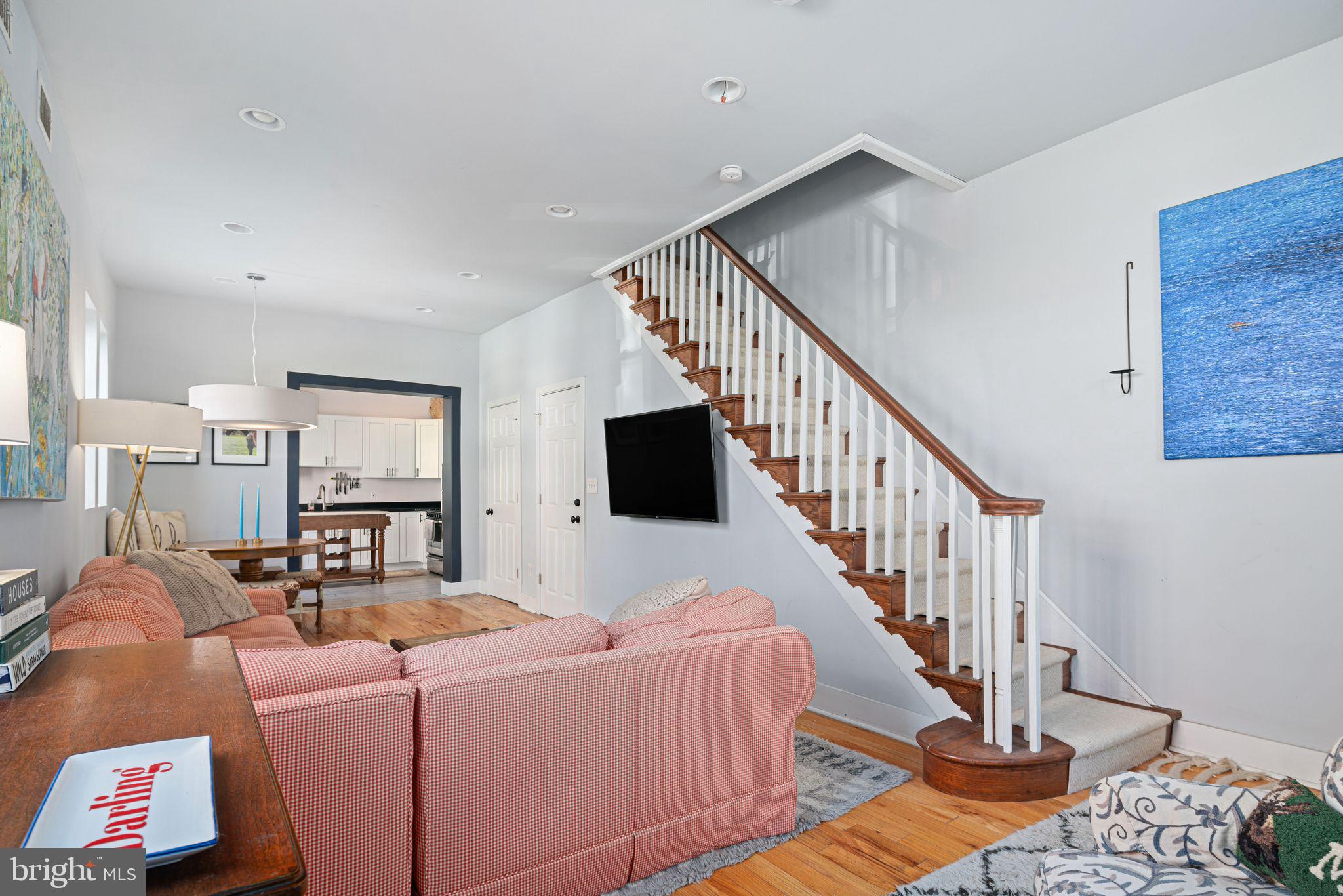 a living room with furniture and stairs