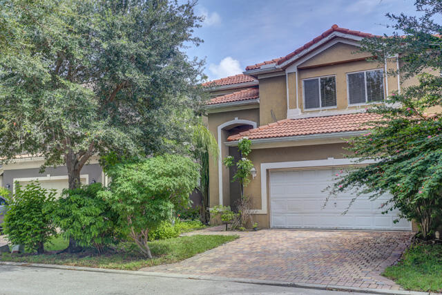 a house that has a tree in front of it