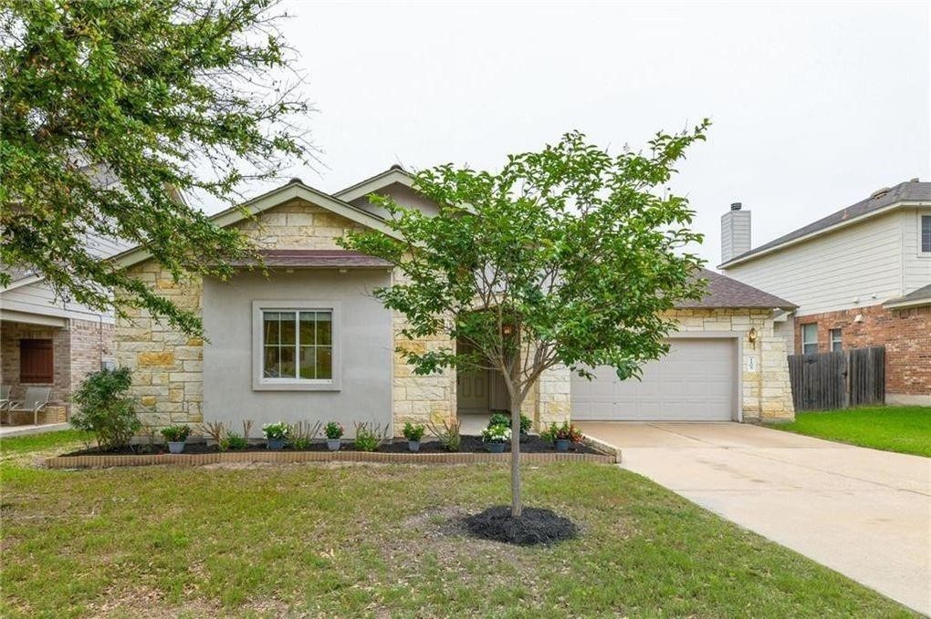 a front view of house with yard and green space