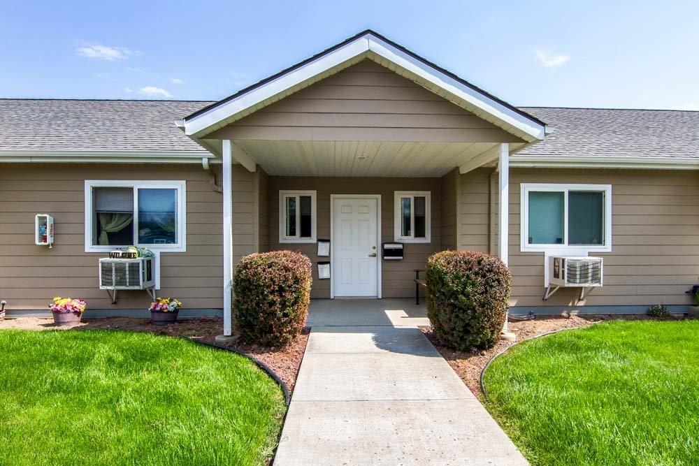 a front view of house with a garden and patio