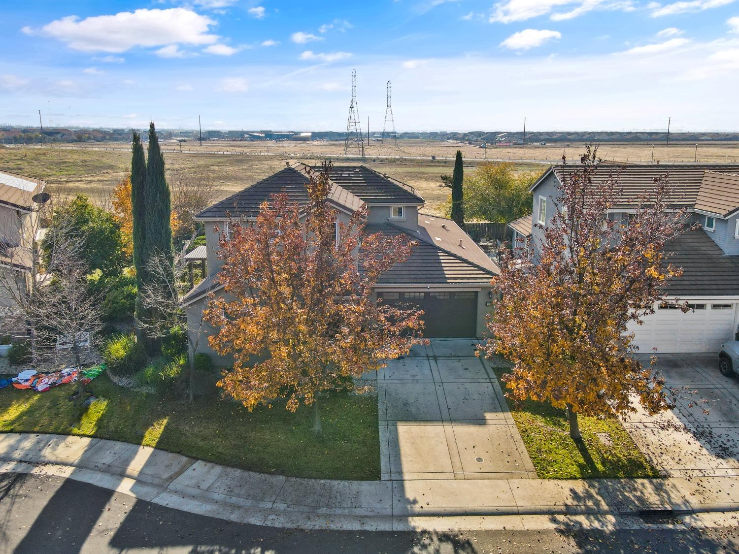 an aerial view of a house with a garden and lake view