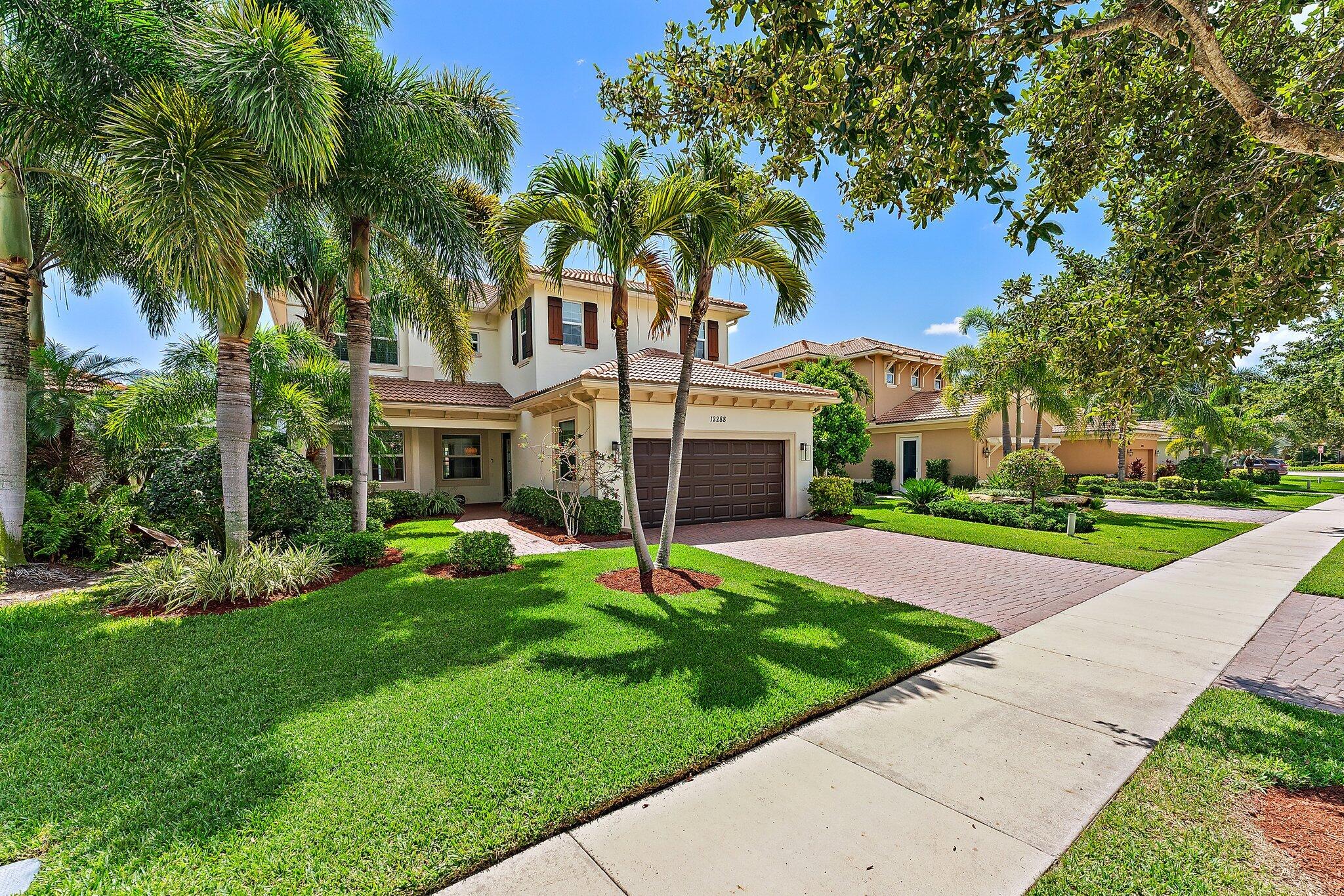 a view of a house with a yard and tree s