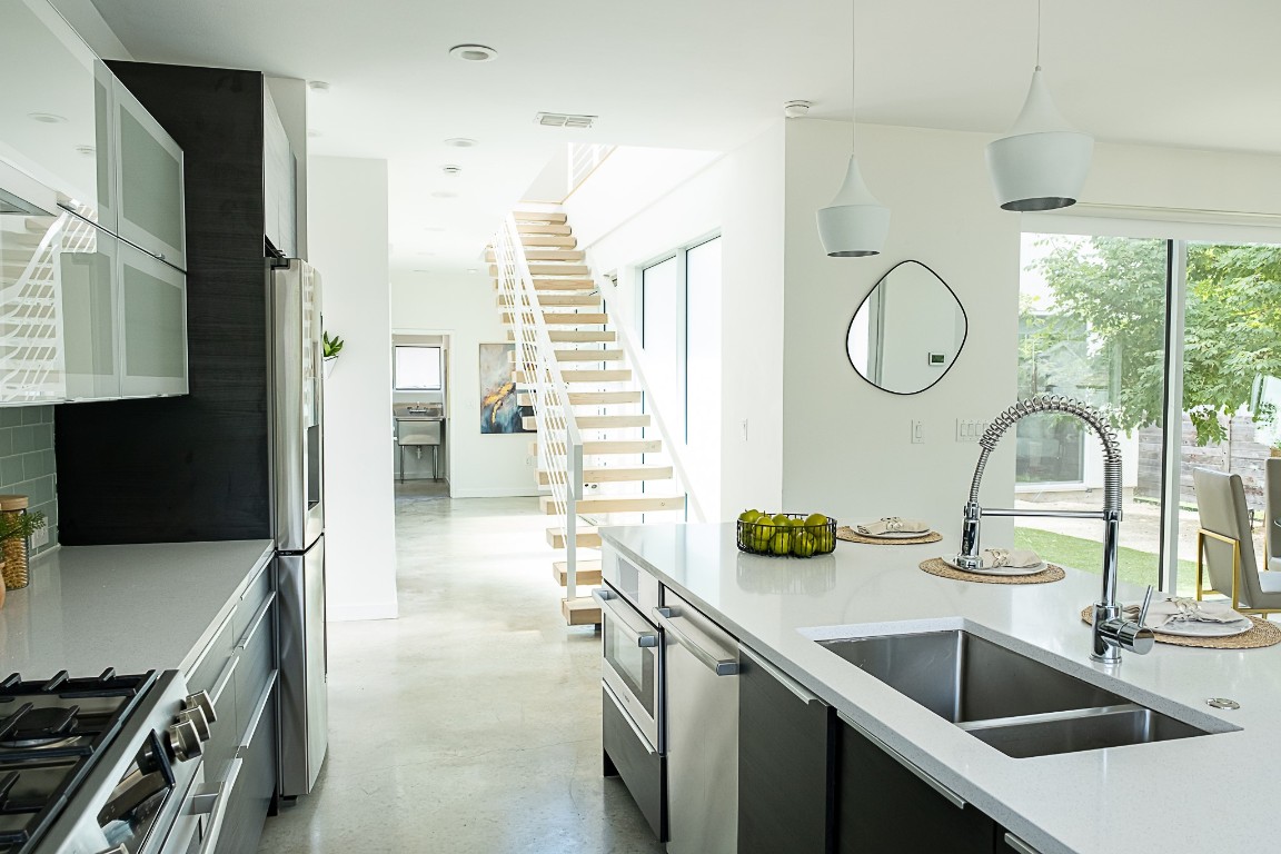 a kitchen with a sink and a refrigerator