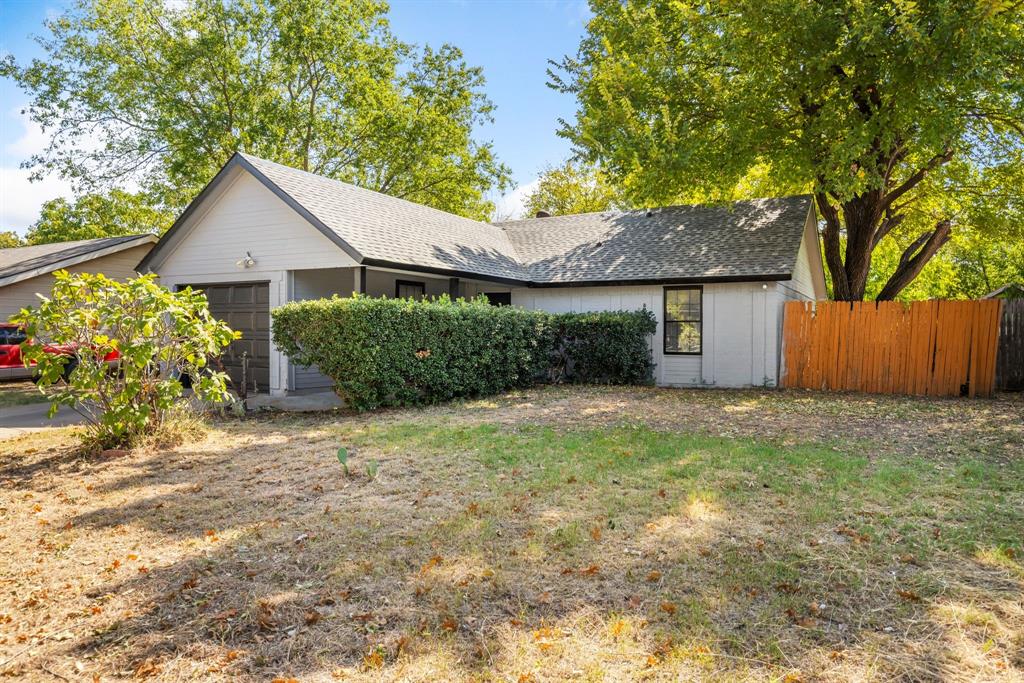 a view of a house with a yard and a garden