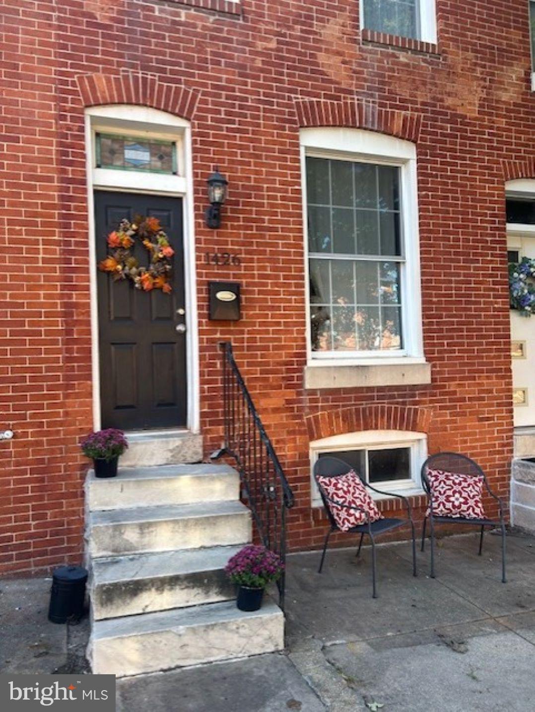 a front view of a house with a bench