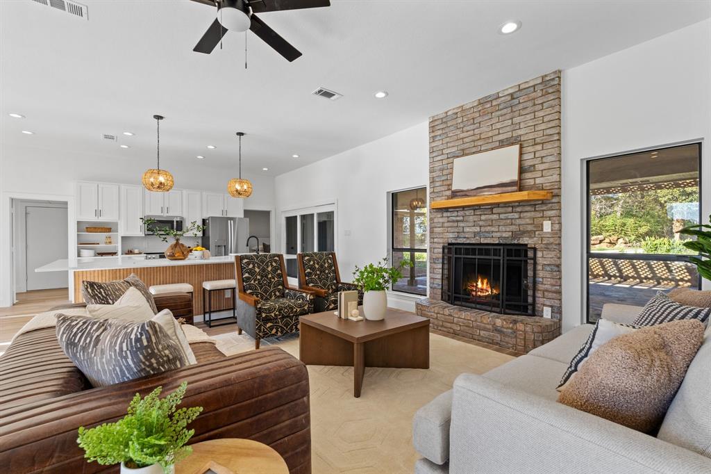 a living room with furniture fireplace and a table