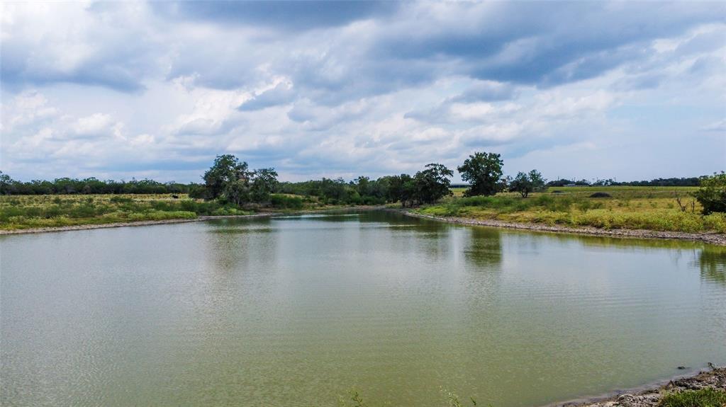 a view of a lake with houses in the back