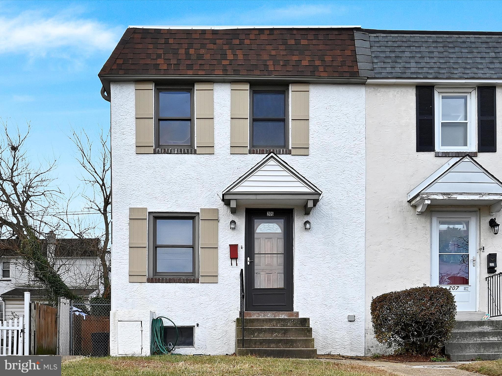 a front view of a house with a wooden fence