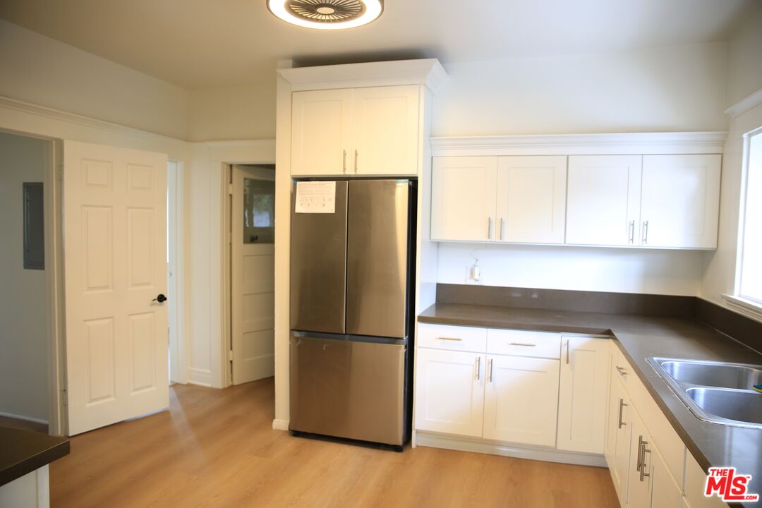 a kitchen with a refrigerator and window