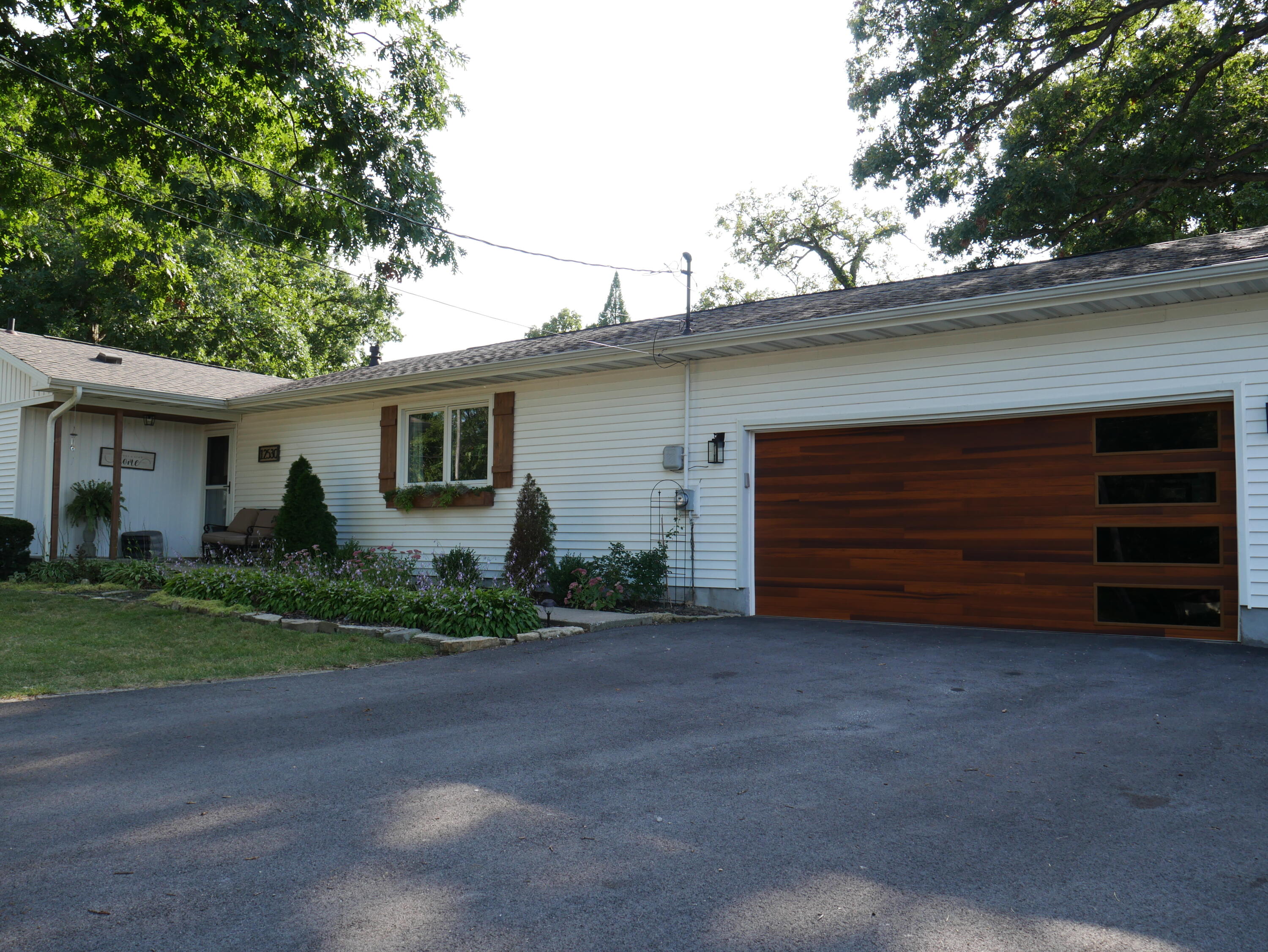 a view of a house with a yard and garage