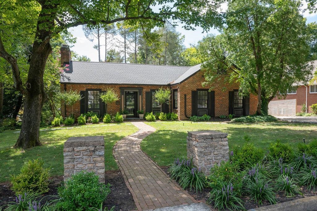 a view of a house with yard and tree s