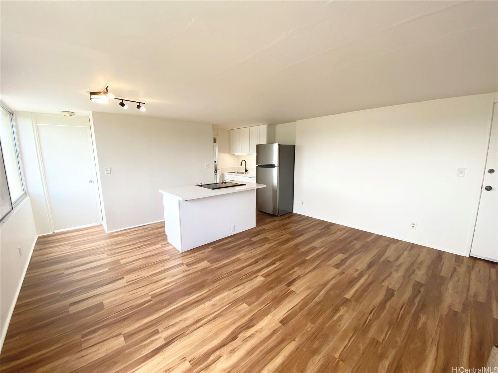 a view of a kitchen with wooden floor and a sink