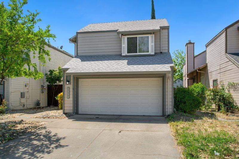 a view of a house with a yard and garage