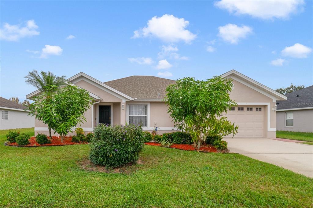 a front view of house with yard and green space