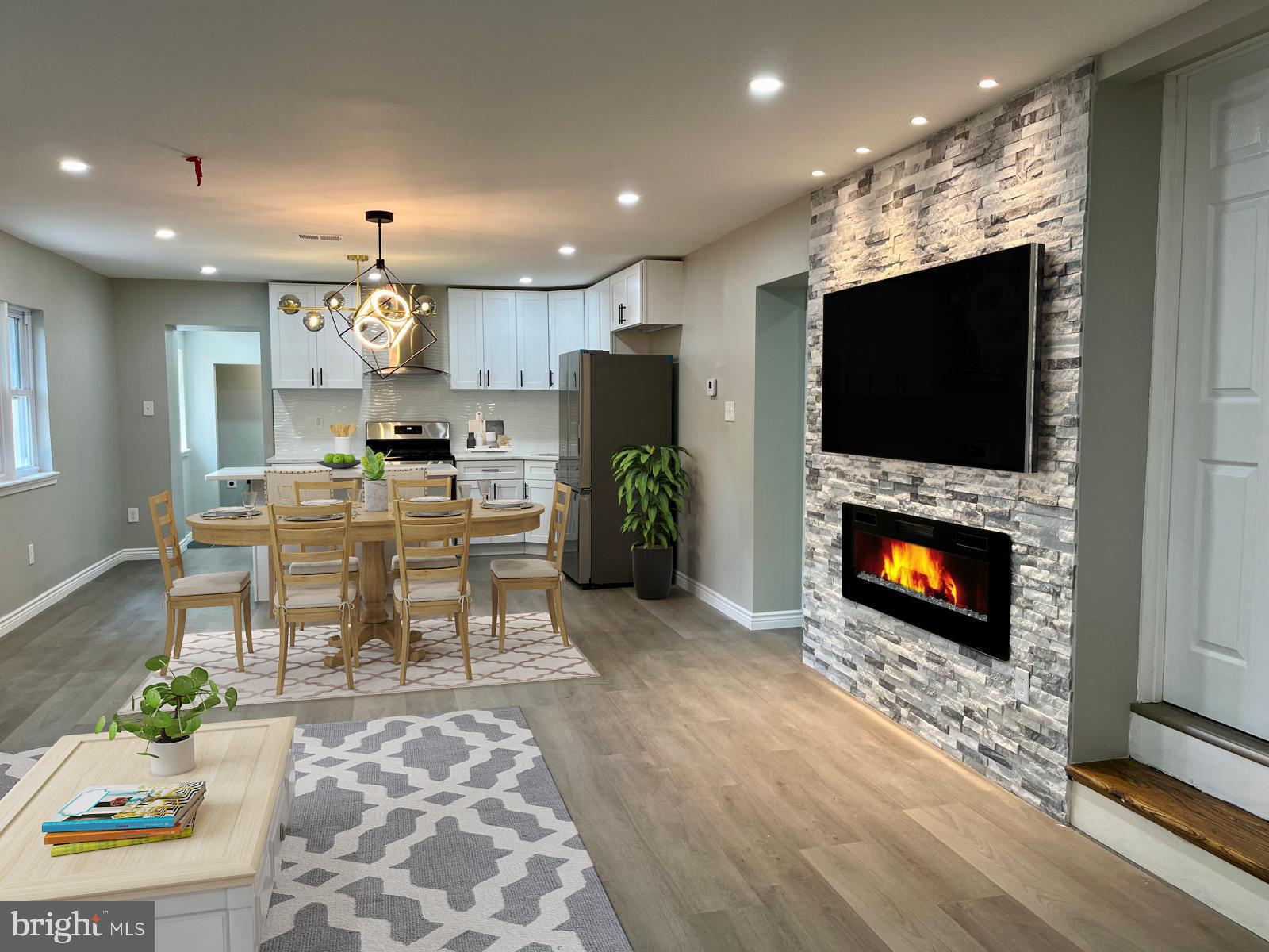 a living room with furniture a flat screen tv and a fireplace