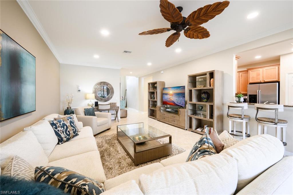 a living room with furniture ceiling fan and a rug