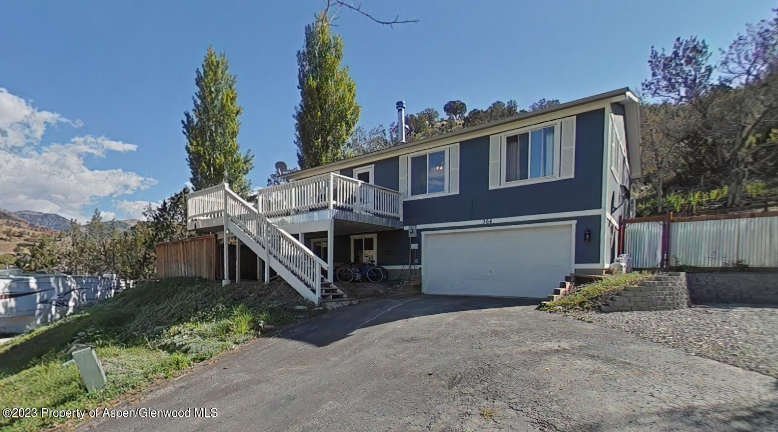 a house that has a tree in front of it