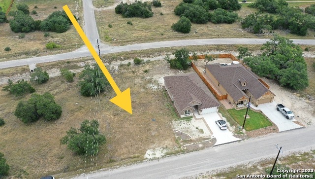 an aerial view of a house with a yard and lake view