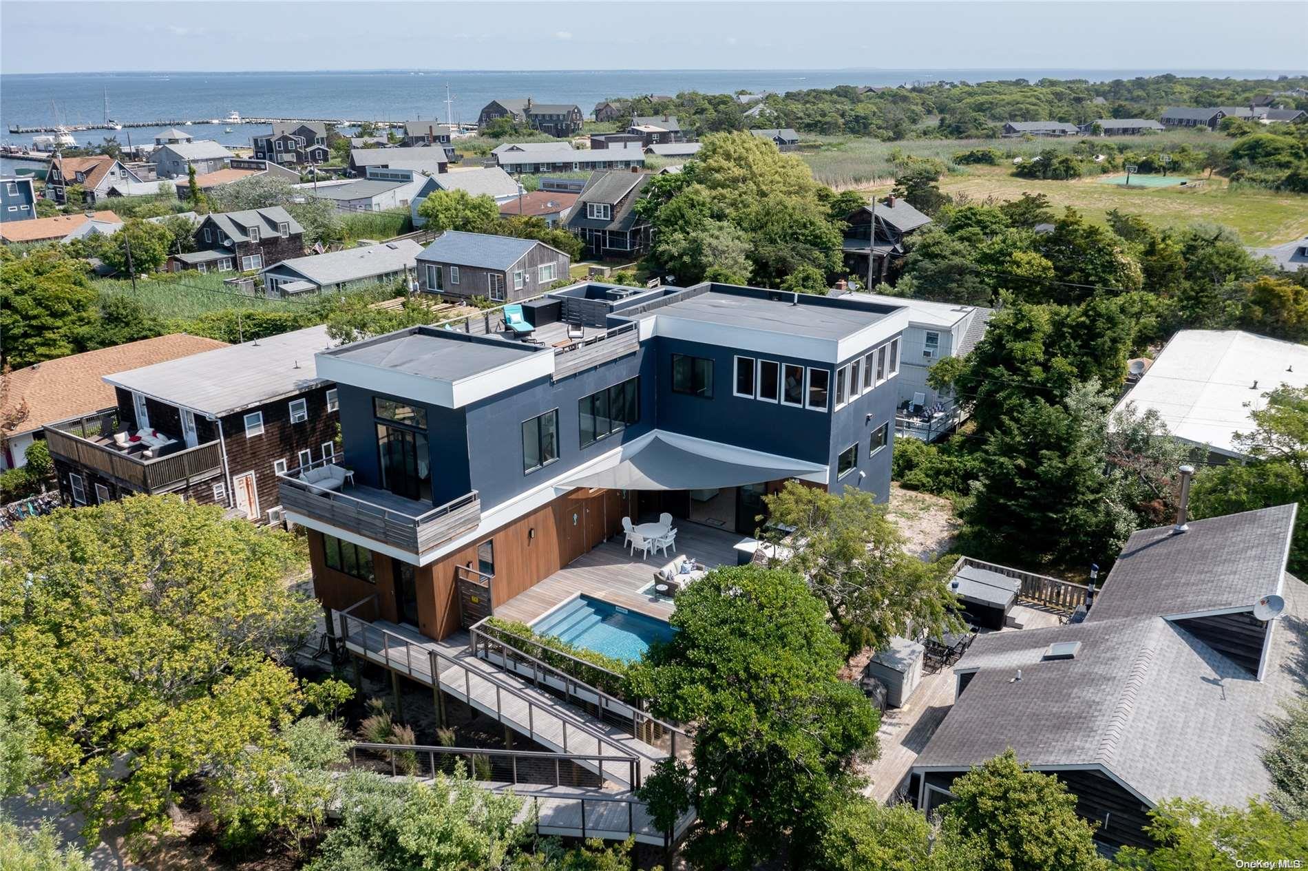 an aerial view of a house with a mountain in the background