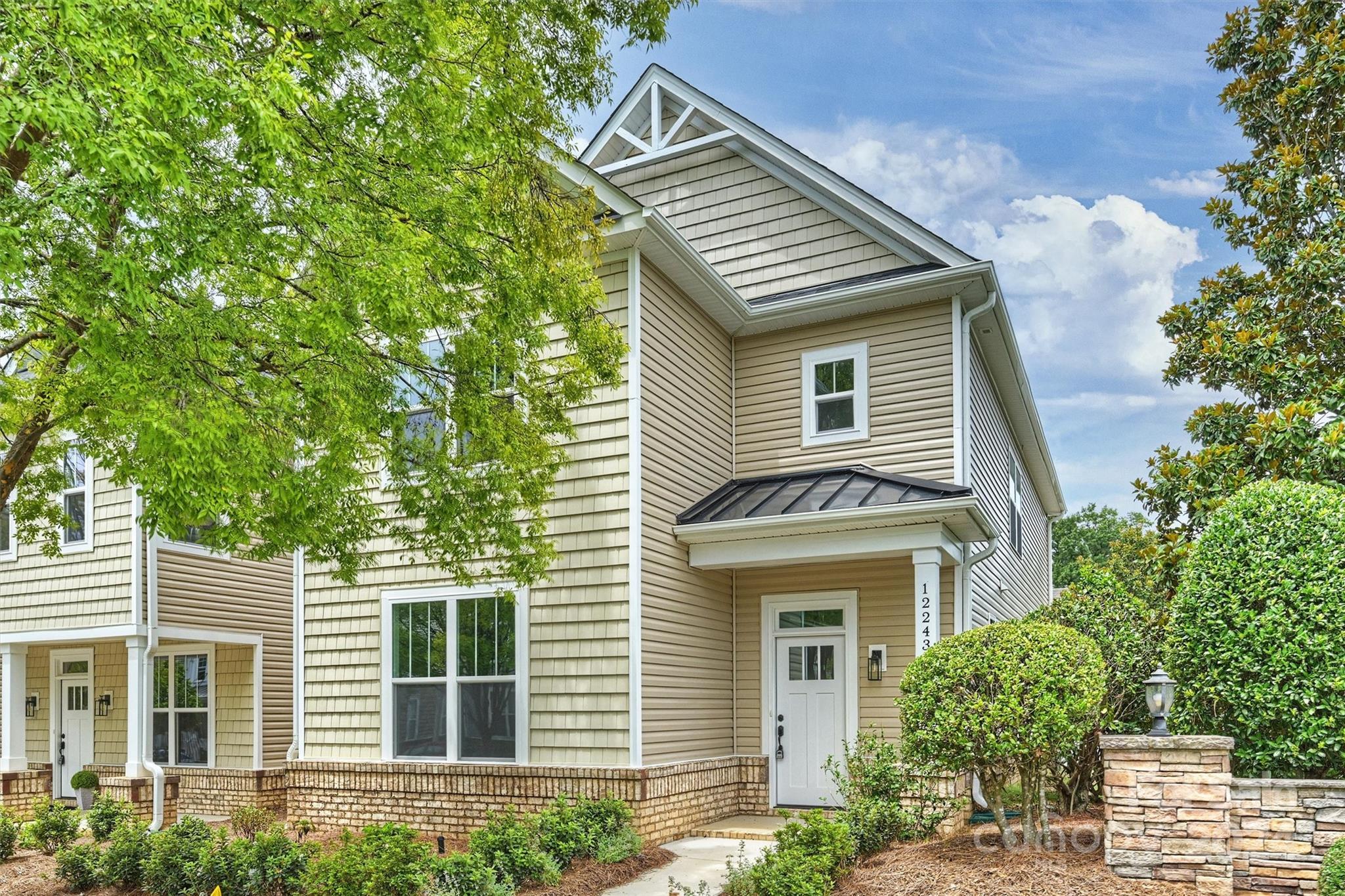 a front view of a house with a garden