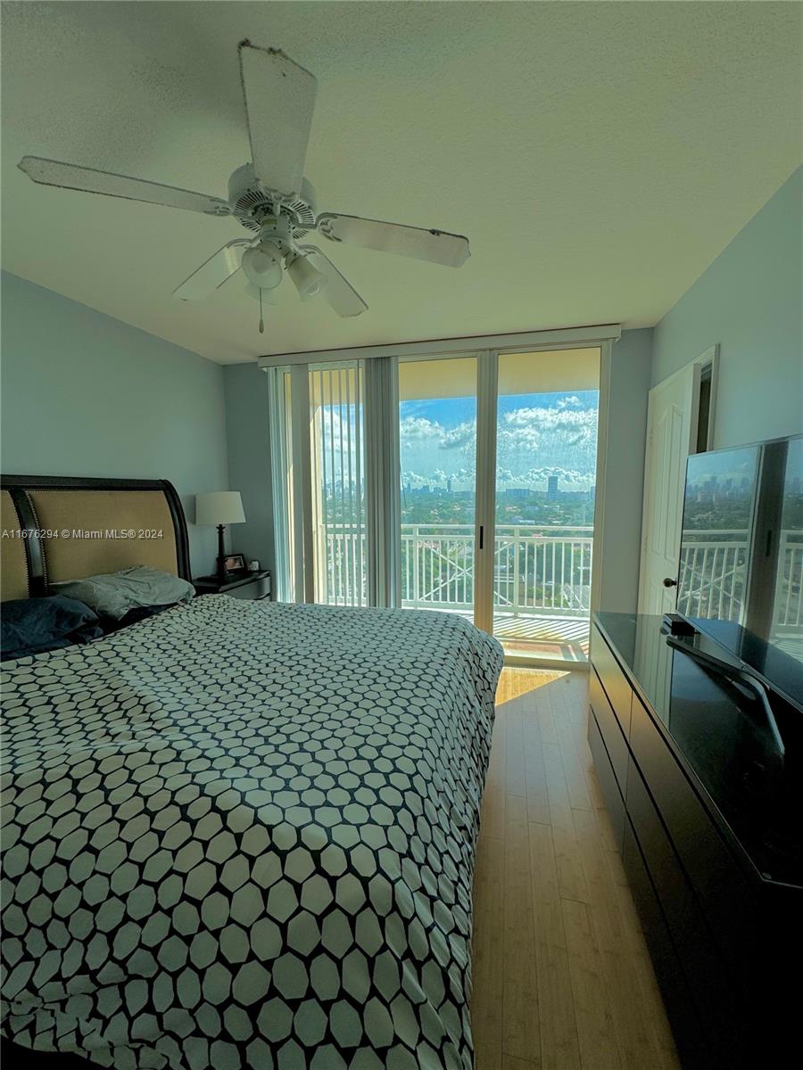 a bedroom with a bed and glass door