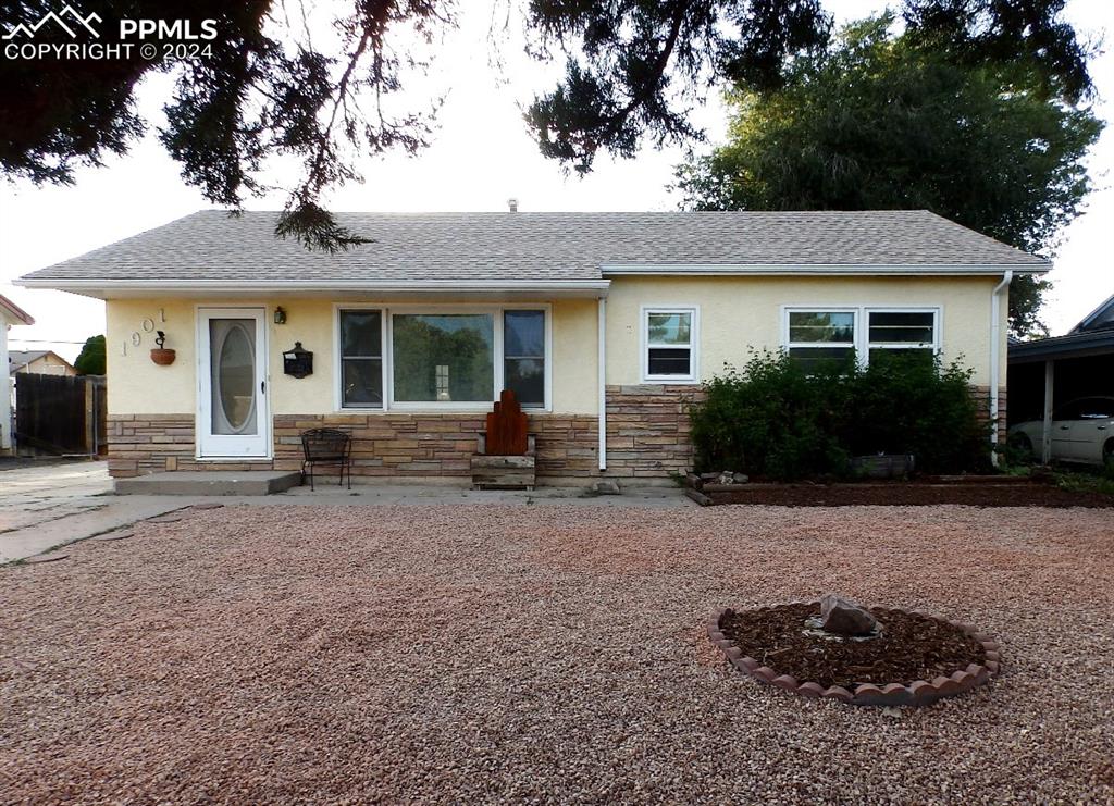 Front of home featuring stone & stucco exterior