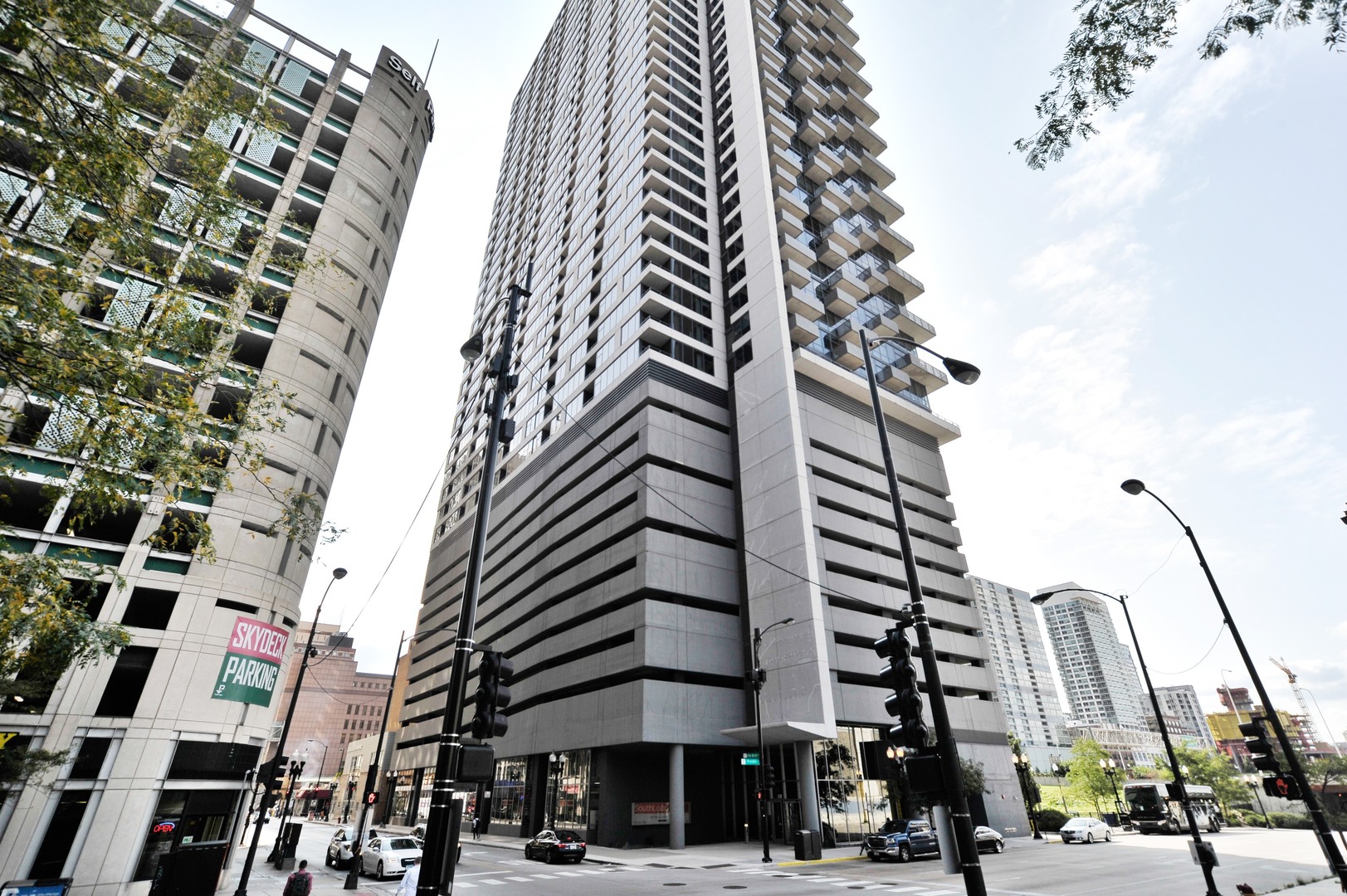 a city street lined with tall buildings and trees