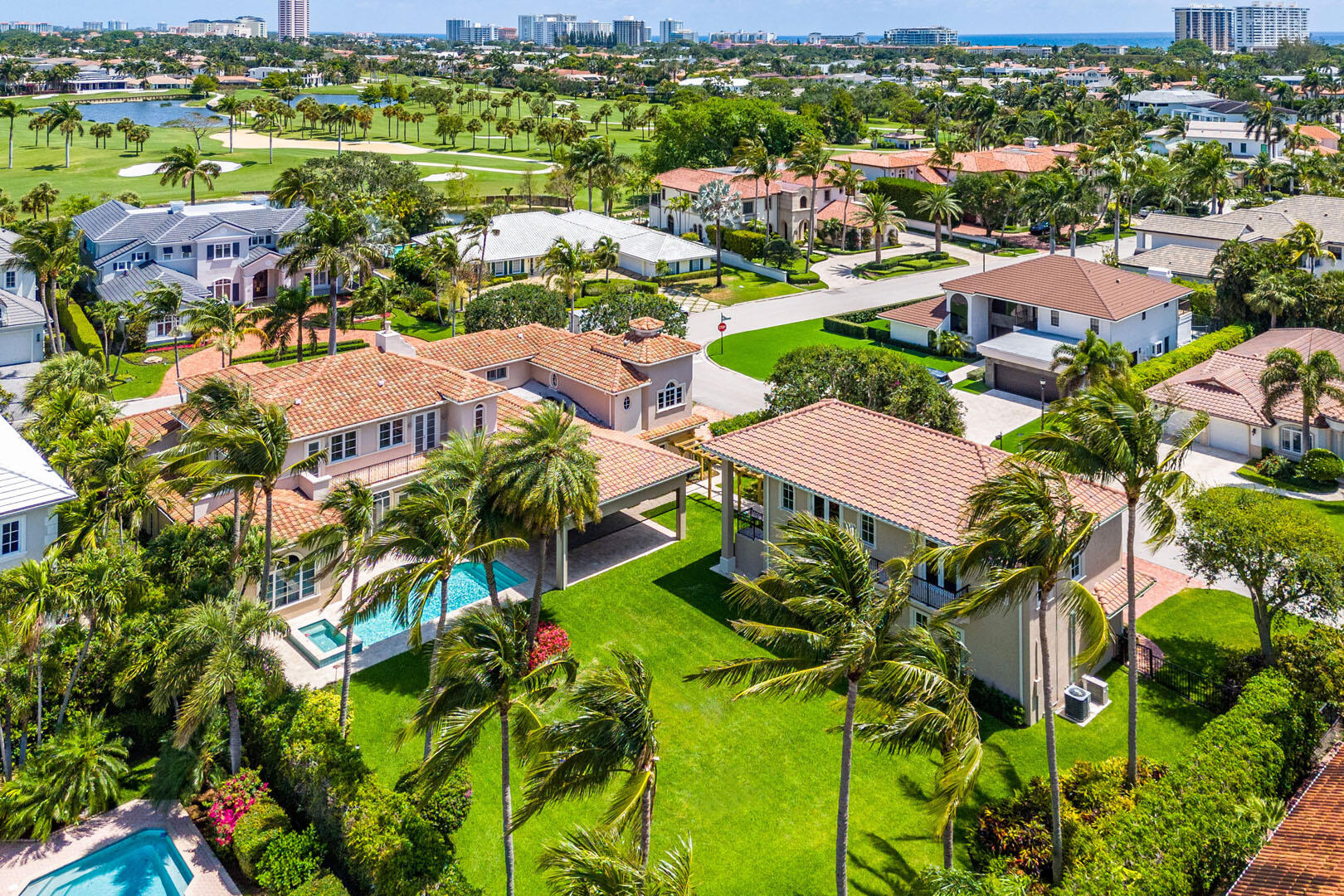 an aerial view of residential houses with outdoor space and street view