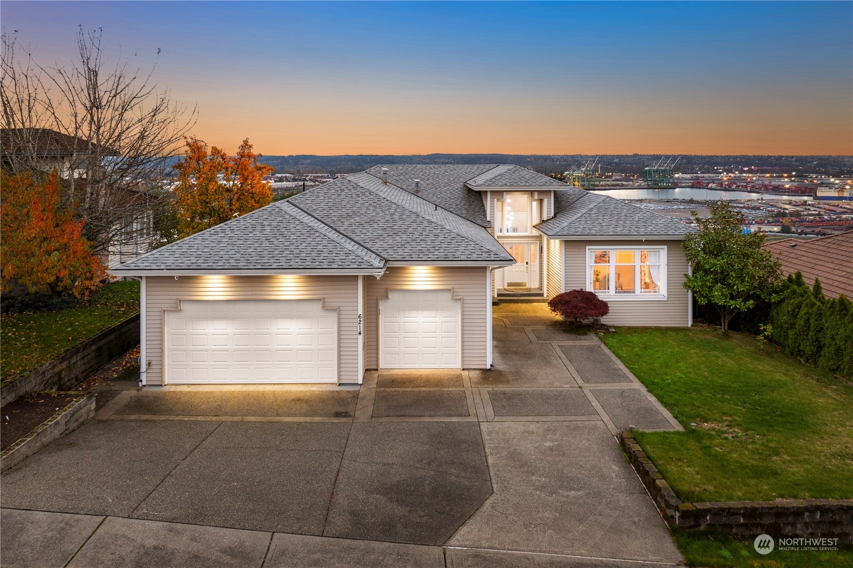 a front view of a house with a yard and garage