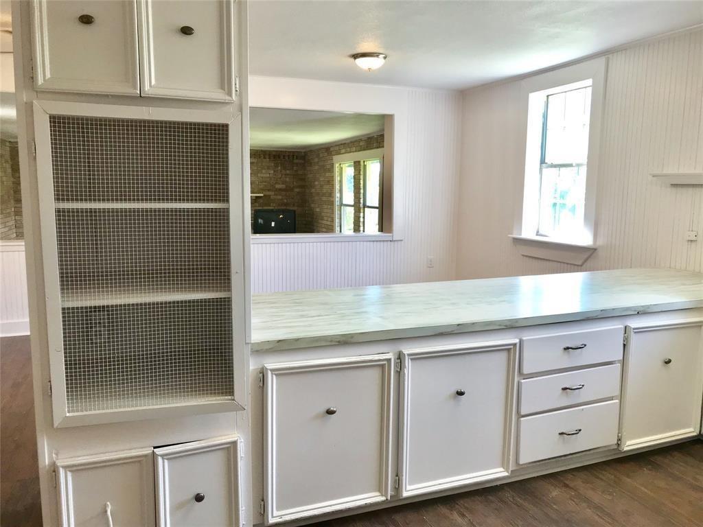 a kitchen with cabinets and window