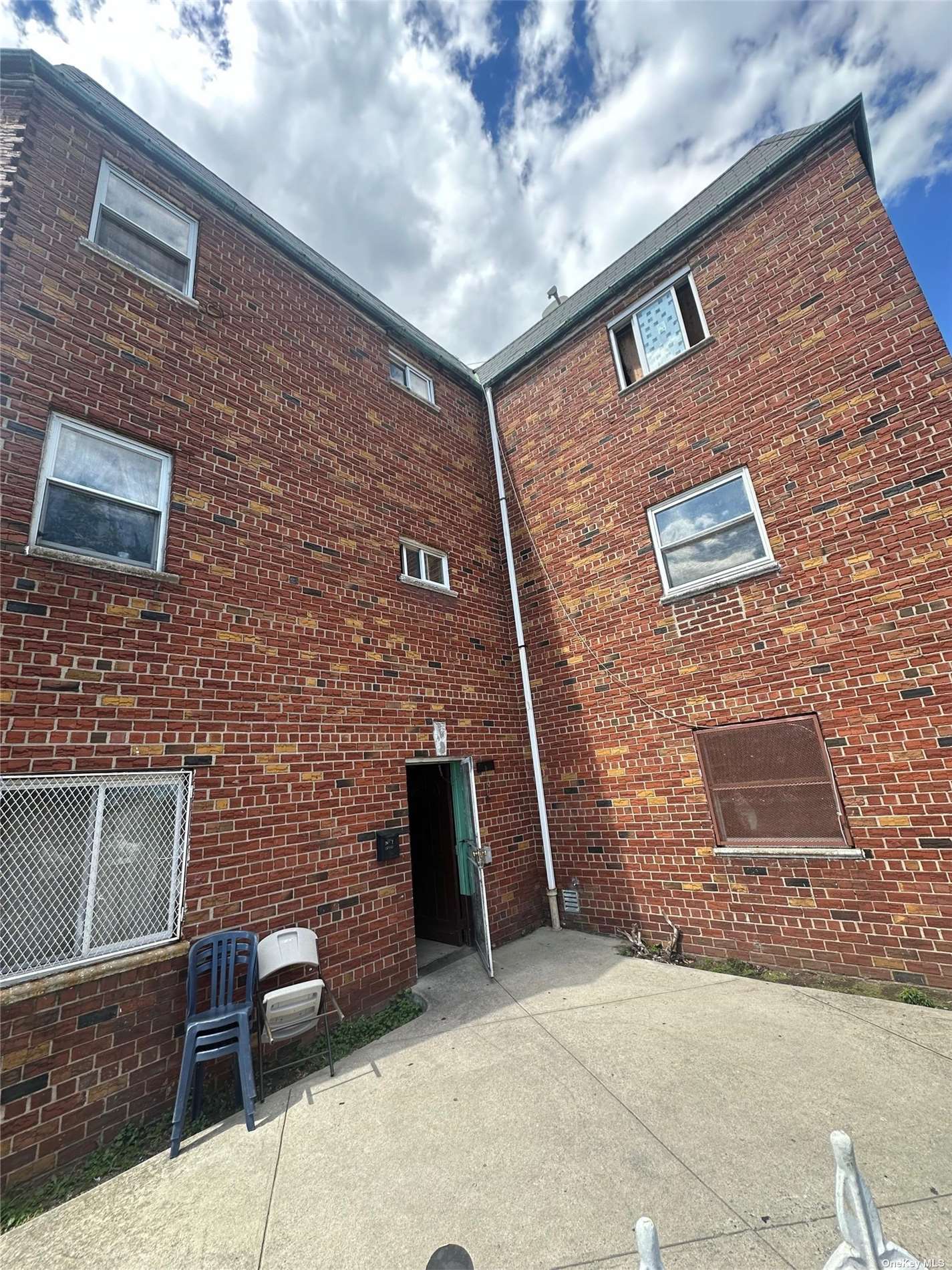 a brick building with a bench and a table