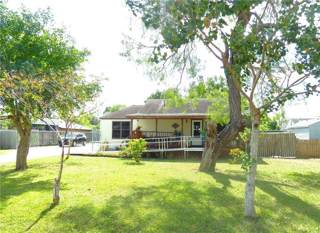 a view of a house with a backyard