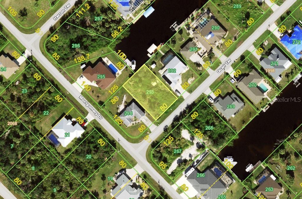 an aerial view of a residential houses with yard