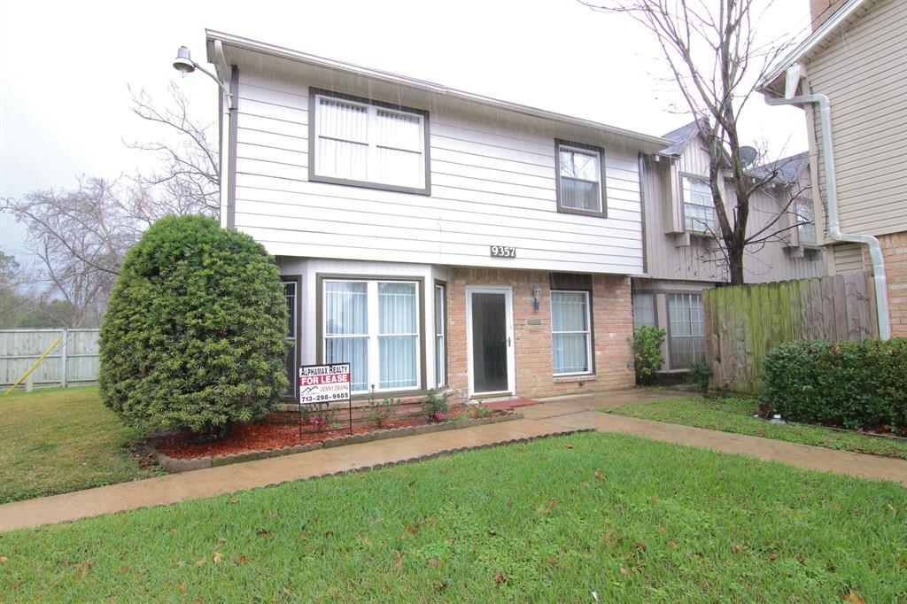 a front view of a house with a yard and outdoor seating