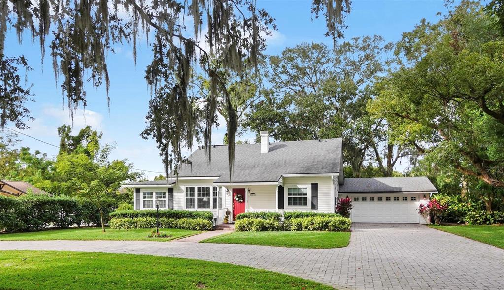 a front view of house with yard and green space