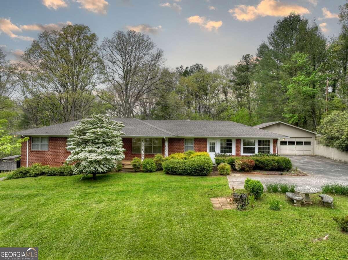 a front view of house with yard and green space