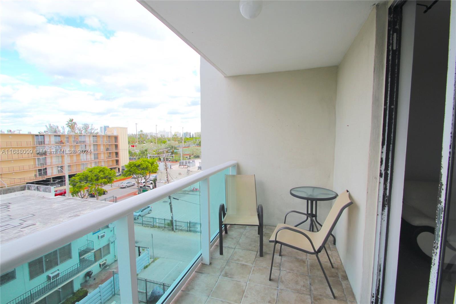 a city view from a balcony with furniture