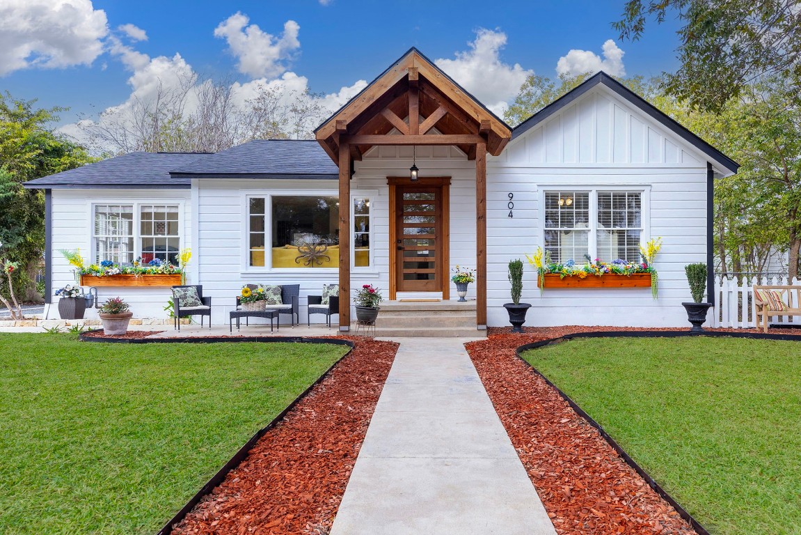 a front view of a house with a garden and patio