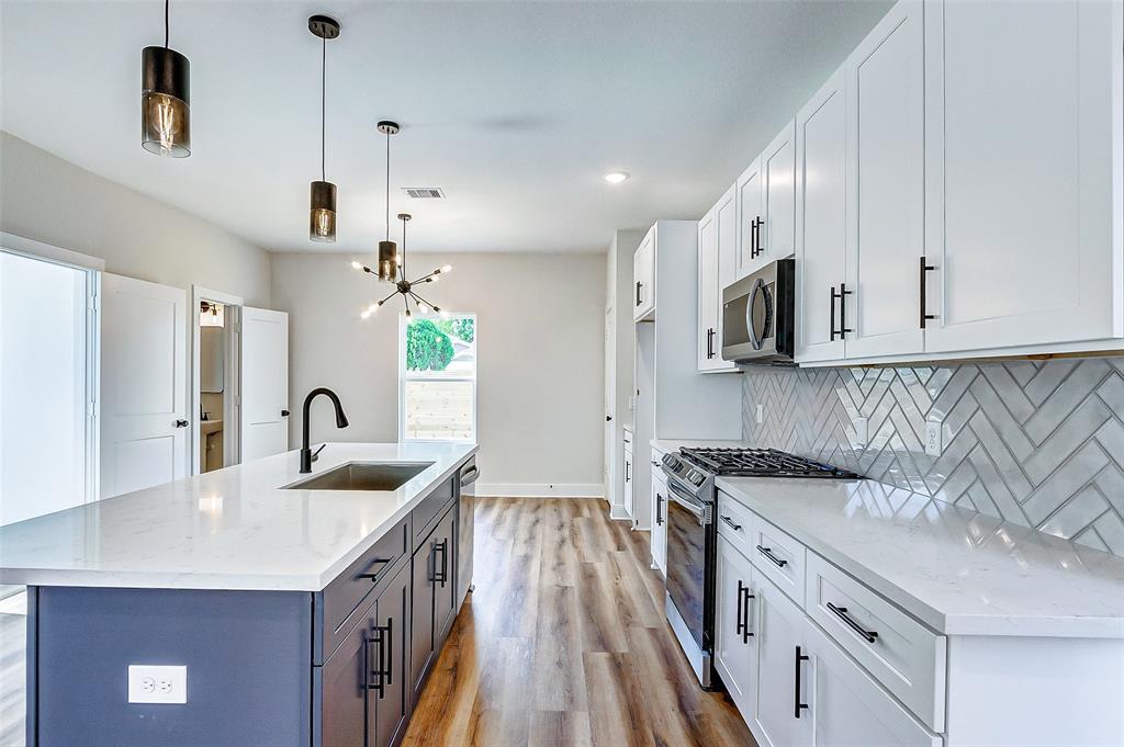The heart of this home is its expansive open floor plan, effortlessly connecting the living, dining, and kitchen areas.